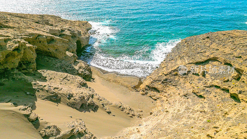 Aerial view of the hidden cove beach "La Rajita" at the natural reserve of "Monta?a Pelada" in Tenerife (Canary Islands). Drone shot